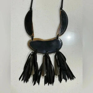 Tribal-inspired necklace made of buffalo horn and leather tassels